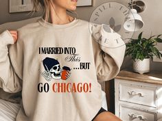 a woman wearing a sweatshirt that says i married two but go chicago