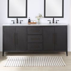 two mirrors are above the double sinks in this bathroom