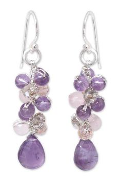 two pairs of earrings with amethorate and pink stones on them, hanging from silver hooks