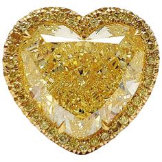 From SCARSELLI this ring has a Huge Sunny Heart. This 12.20 carat Fancy Intense Yellow Heart shape diamond (GIA graded VS1 ) is surrounded by Yellow diamonds in an 18 karat Yellow gold hand made ring. The presentation of this diamond is large and seamless with the addition of a halo of round yellow diamonds. This ring may be sized or re-designed with Scarselli to suit the client's specifications. Should a client wish to customize settings to personalize the look, such as changing side stones or Fancy Yellow Diamond Ring, Life Jewelry, Contemporary Engagement Rings, Yellow Diamonds, Yellow Diamond Rings, Fancy Yellow Diamond, Family Jewels, Yellow Heart, Radiant Cut Diamond