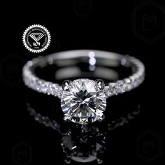 a diamond ring with diamonds around it on a black background and an award seal in the middle