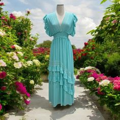 This Stunning Mint Green Maxi Dress By Picara Features A Flattering V-Neckline, Crochet Lace Details, And Flutter Sleeves For A Feminine And Bohemian Touch. The Flowy, Ruffle Hem Adds A Whimsical Feel, Making It Perfect For Summer Outings, Beach Days, Or Casual Events. The Lightweight Fabric And Relaxed Fit Provide Ultimate Comfort, While The Adjustable Tie-Back Design Ensures A Customizable Fit. This Boho-Chic Dress Is Versatile Enough To Dress Up Or Down, Making It A Must-Have Addition To Any Tiered Lace Trim Beach Dresses, V-neck Maxi Dress With Lace Patchwork For Beach, V-neck Lace Patchwork Maxi Dress For Beach, Bohemian Lace Tiered Maxi Dress, Blue Lace Patchwork Dress For Vacation, Bohemian Dress With Lace Trim And Flutter Sleeves, Spring Tiered Dresses With Crochet Trim, Beach Maxi Dress With Flutter Sleeve And Ruffles, V-neck Ruffled Lace Maxi Dress