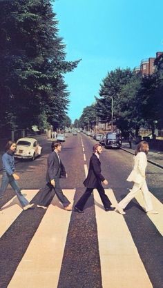 an image of the beatles walking across the street