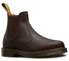 The Dr. Martens 2976 Chelsea boot is a slick, uncompromisingly fashion-forward look for both men and women. Made with naturally distressed Crazy Horse leather, this easy-on, easy-off boot serves up a sure fit with its signature elastic ankle gusset. Elastic gussets Chelsea boot style Made with all the classic Docs DNA, 2976 Chelsea Boots, Dr Martens Chelsea, Dr Martens 2976, Chelsea Boots Style, Fur Accessories, Boots Uk, Tripp Nyc, Crazy Horse, Goodyear Welt