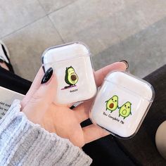 two air pods with avocado stickers on them