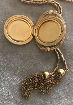 "Vintage A-C 12K Gold-filled Locket Tassel Lariat Pendant Necklace. Size: Necklace- 29\"x 3/16\"(3mm). Locket: 1\"x1 1/4\" round. Markings: A-C 1/20 12KT GF. Beautiful. Sold as is. Pre-Owned." Bohemian Lariat Jewelry For Formal Occasions, Luxury Formal Tassel Jewelry, Elegant Medallion Locket Necklace With Adjustable Chain, Elegant Locket Necklace With Adjustable Chain, Vintage Engraved Lariat Jewelry, Elegant Bronze Round Locket Necklace, Bohemian Jewelry With Adjustable Chain For Formal Occasions, Gold Tassel Jewelry For Evening, Gold Long Tassel Necklace