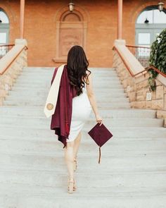 a pregnant woman walking down some steps