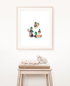 an animal is sitting on a stool in front of a wall with a duck print