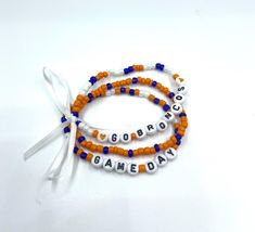 This listing is for a set of 3 beaded stretch bracelets that are tied together with a white ribbon. Perfect for Denver Bronco fans! Denver Bronco, Go Broncos, Broncos Fans, White Ribbon, Beaded Stretch Bracelet, Stretch Bracelets, Game Day, Favorite Jewelry, Denver