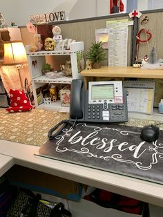 an office desk with a phone on it