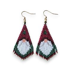 a pair of beaded earrings with an image of a santa clause on the front