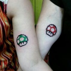 two people with matching tattoos on their arms