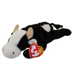 a black and white cow laying down with a tag on it's ear,