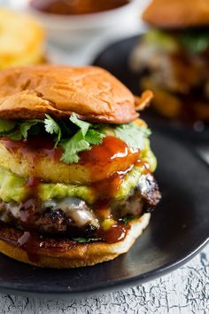 a burger with meat, lettuce and tomato sauce