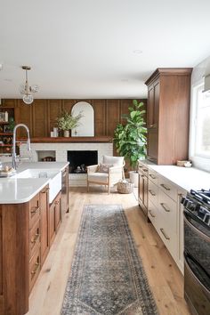 a kitchen with wooden cabinets and an area rug in front of the stove top oven