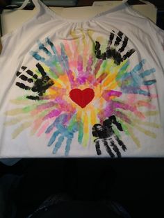 a t - shirt with handprints on it and a heart in the middle