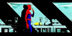 a spider man standing in front of a kitchen