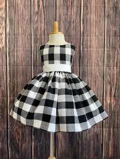 Little Darln Boutique Black & White Plaid dress that's perfect for any occasion: Christmas, photoshoot, wedding, birthday & More! This dress is made out of a comfortable cotton plaid. Bodice consists of a White satin sowed in sash (not removable) followed by plaid fabric that can be used to tie together into a bow at the back of the dress for a snug fit, followed with a hidden zipper. The plaid skirt has a layer on lining with crinoline attached to give the skirt some fullness. Petticoat is used to show full detail (NOT INCLUDED) Can be purchased separately! https://www.etsy.com/listing/1316417982/white-knee-length-petticoat-wedding?click_key=6abc7feb8e0e762dcafc93039a38eb4d928dfc29%3A1316417982&click_sum=70e051d8&ref=shop_home_active_1 Visit our store, more items to come!  https://www.ets Black And White Plaid Dress, Country Cow, Photoshoot Wedding, Puffy Dresses, Summer Christmas, Birthday Girl Dress, Christmas Photoshoot, Wedding Summer, Cow Girl