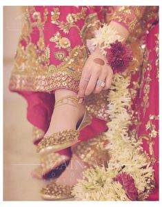 a close up of a person wearing shoes with flowers on the floor and in front of her