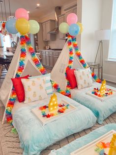 two beds are decorated with balloons and other decorations for a birthday or baby's first birthday