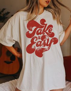 Take it easy in a dark yam color font on a white tee shirt as shown. You may change the color of the tee with the color chart provided! This is a high quality bo ho tee that is 100% ringspun cotton, and 99% preshrunk. It is oversized so you can order your size and it will fit like your boyfriends worn in vintage tee. Size up a size for oversized relaxed fit, or go up 2 sizes for the t shirt dress wear around the house by itself tee. They are sooooo comfy and soft it will become your favorite tee T Shirt Fonts, Pawsitive Vibes, Bo Ho, White Tee Shirt, Side Bar, Monkey Art, Hippie Shirt, Dance Shirts, White Tee Shirts