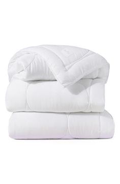 the white sheets and pillows are stacked on top of each other in front of a white background