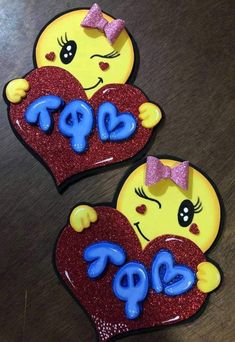 two yellow and red heart shaped magnets with the word pop written in blue on them