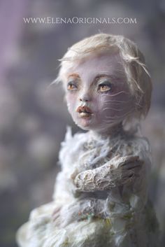 a doll with white hair and blue eyes