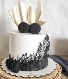 a white cake with black decorations on top