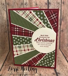 a christmas card made with plaid paper and red, green, and white colors on wood background