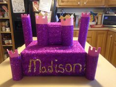 a cake made to look like a castle with the word madison on it's side