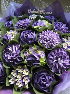 a bouquet of purple flowers with green leaves