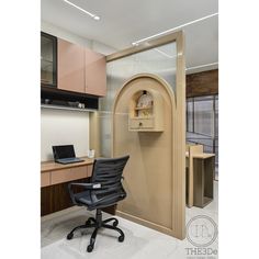 an office cubicle with a computer desk and chair in front of the door that is open