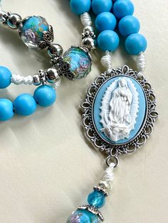 Welcome to my Shop "CREATING STILL MOMENTS."   To see all my listings and offerings, please visit my shop at  https://www.etsy.com/shop/CreatingStillMoments?ref=sh-carousel-1  handmade rosary using beautiful Blue wooden Beads and beautiful blue glass "our father" beads.  These rosaries are beautiful and would make a wonderful First Communion/Reconciliation or Confirmation gift, wedding gift, or RCIA PSR gift. or Catholic mom gift.  The colors are vibrant and gorgeous!  The bronze indulgence cruc Spiritual Blue Jewelry For Mother's Day, Mother's Day Rosary With 8mm Beads, Blue Rosary, Handmade Rosary, Catholic Women, Confirmation Gifts, Gift Wedding, Mom Gift, Wooden Beads