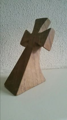 a wooden cross on a white table