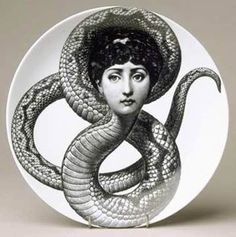 a black and white drawing of a woman with a snake wrapped around her head on a plate