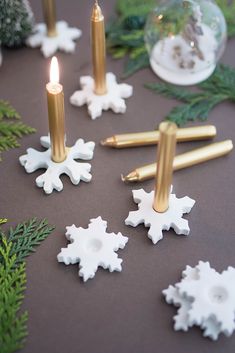 some candles and snowflakes on a table