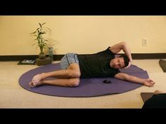 a man laying on top of a yoga mat in front of a woman with her hands behind her head