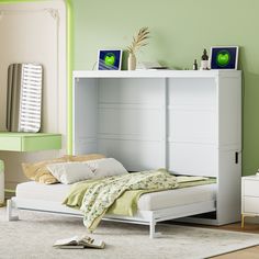 a bedroom with green walls and white furniture