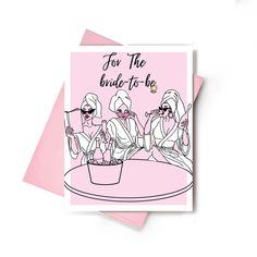 two women sitting at a table with drinks in their hands and the words for the bride to be on it