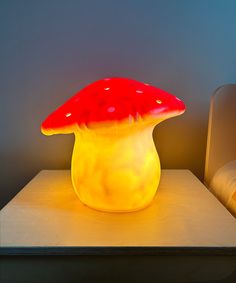 a mushroom shaped lamp sitting on top of a table