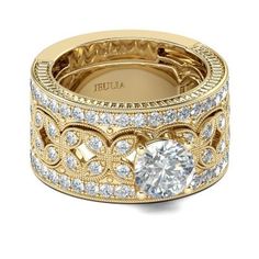 a yellow gold diamond ring with an intricate design on the band and center surrounded by round brilliant cut diamonds