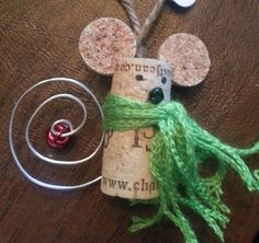 a mouse made out of wine corks and some string on a table with other items