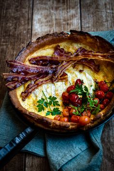 an omelet with bacon, tomatoes and parsley