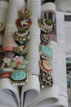 an open book with many different brooches on it