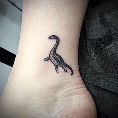 a small tattoo on the ankle of a woman's foot, depicting a duck