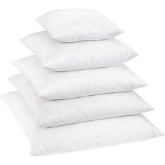 four white pillows stacked on top of each other