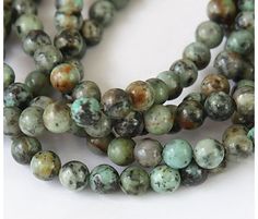 two strands of green and brown marble beads