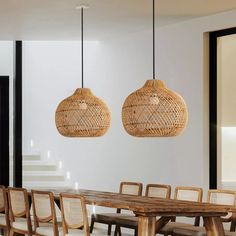 a dining room table and chairs with wicker lamps hanging from the ceiling over them