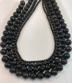 High Quality Astrophyllite Beads.  Appears black with gold flecks.  Some of the beads look dark brown.  Under a light it sparkles.  It is a rare form Titanium Silicate.Quantity:  One 15"  strand Shape:   RoundSize:  4, 6, 8, 10, 12mm availableFinish: Smooth ShinyFind more gemstone strands here: https://www.etsy.com/shop/thebeadgalleryA2?section_id=24259658Processing time:1-3 daysShipping:2-5 days standard USPS shipping methods. Black Beaded Necklaces With 8mm Round Beads, Black Beaded Necklaces With 8mm Beads, Obsidian Necklace With Black Round Beads, Black Bohemian Round Beads, Black Round Gemstone Beads, Artisan Black Beads 8mm, Black Gemstone Round Beads, Black Faceted Round Beads, Gold Flecks